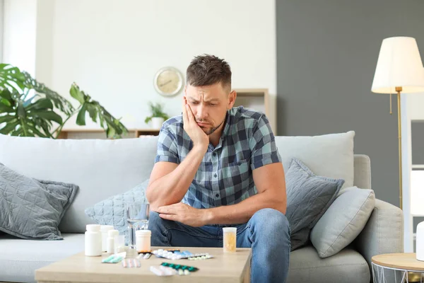 Ill man with many different medicines at home — Stock Photo, Image