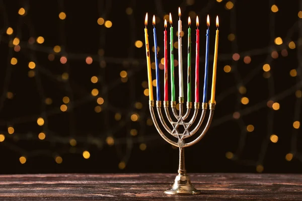 Menorah with candles for Hanukkah on table against dark background — Stock Photo, Image