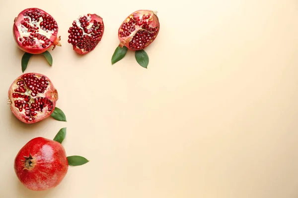 Ripe tasty pomegranates on color background — Stock Photo, Image