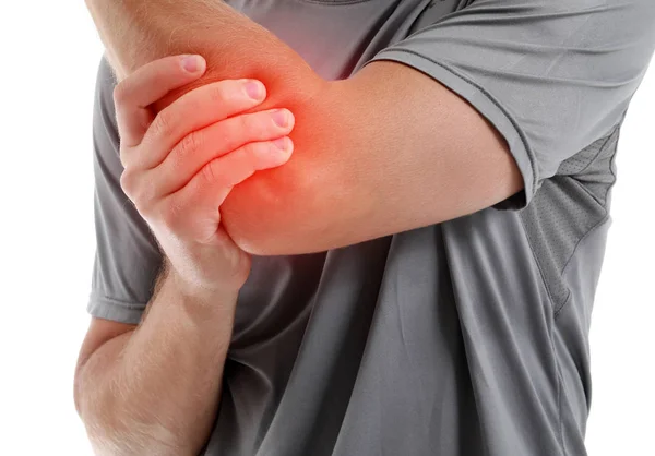 Young man suffering from pain in elbow on white background, closeup — Stock Photo, Image