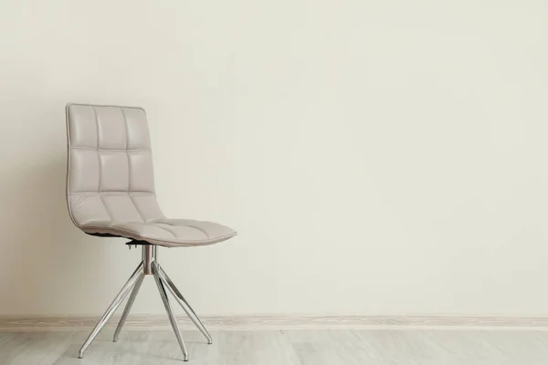 Cozy chair near white wall in room — Stock Photo, Image