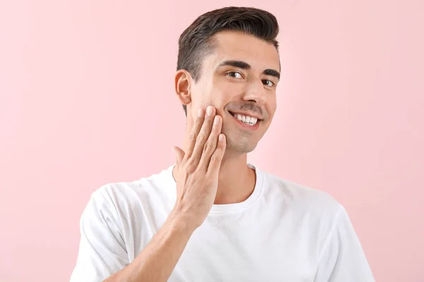 Schöner junger rasierter Mann auf farbigem Hintergrund — Stockfoto