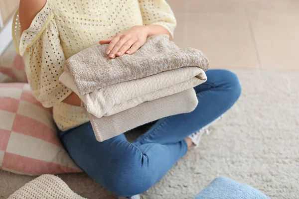 Woman with stack of clean clothes at home, closeup — Stock Photo, Image