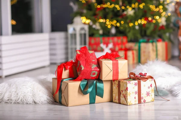 Many Christmas gifts on floor in room — Stock Photo, Image