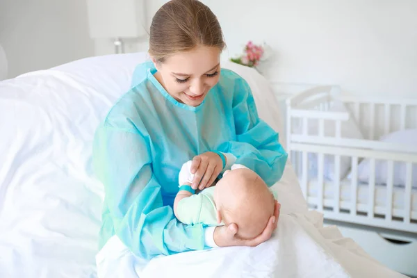 Молодая женщина с новорожденным ребенком в родильном доме — стоковое фото