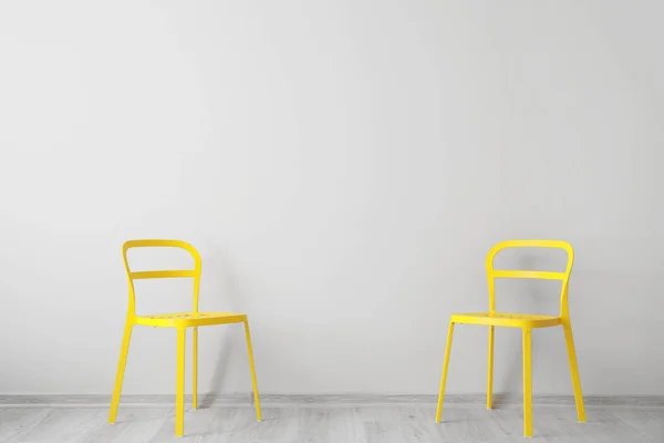 Stylish chairs near light wall — ストック写真