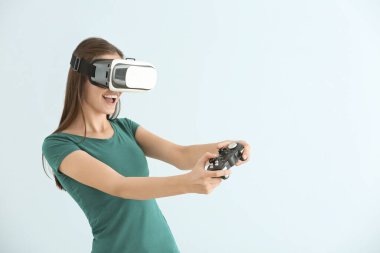 Sanal gerçeklik gözlüklü genç kız arka planda video oyunları oynuyor