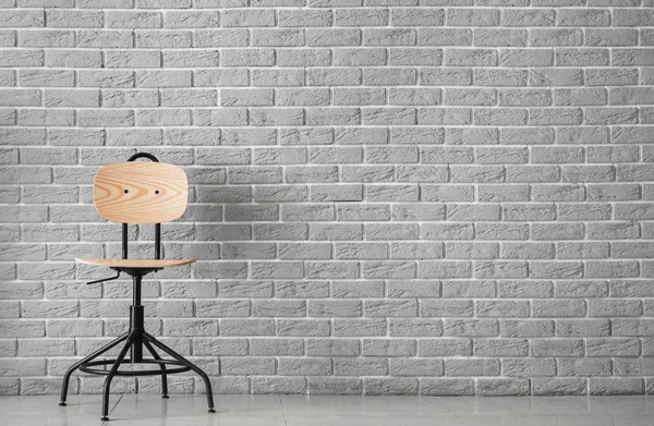 Wooden chair near brick wall — Stock Photo, Image