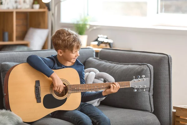 Little boy playing guitar at home — Stock Photo, Image