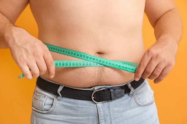 Overweight man measuring his waist, closeup. Diet concept — Stock Photo, Image