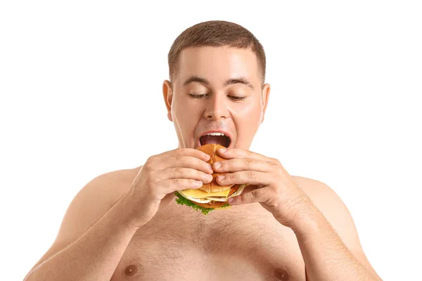 Sovrappeso uomo mangiare hamburger contro sfondo bianco — Foto Stock