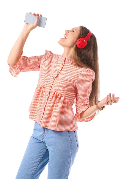 Beautiful young woman listening to music and singing on white background — Stock Photo, Image