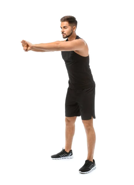 スポーティな若い男が白い背景に対してトレーニング — ストック写真