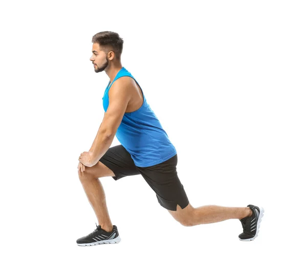 Sporty young man training against white background — Stock Photo, Image