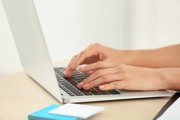 Beautiful young businesswoman working on laptop in office, closeup — Stock Photo, Image