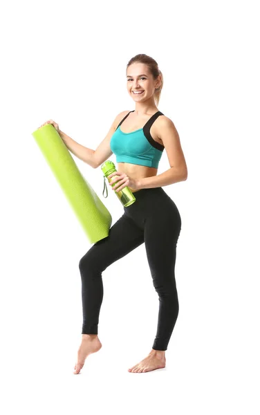 Hermosa joven con esterilla de yoga y botella de agua sobre fondo blanco — Foto de Stock