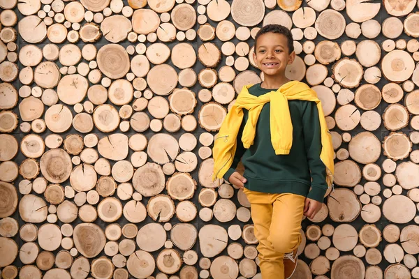 Fashionable African-American boy in autumn clothes near wooden wall — Stock Photo, Image