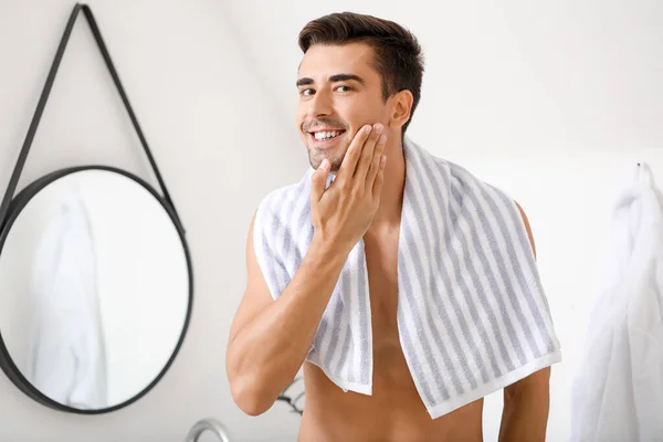 Handsome young man after shaving at home — Stock Photo, Image