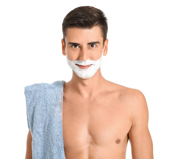 Handsome young man with shaving foam on his face against white background — Stock Photo, Image