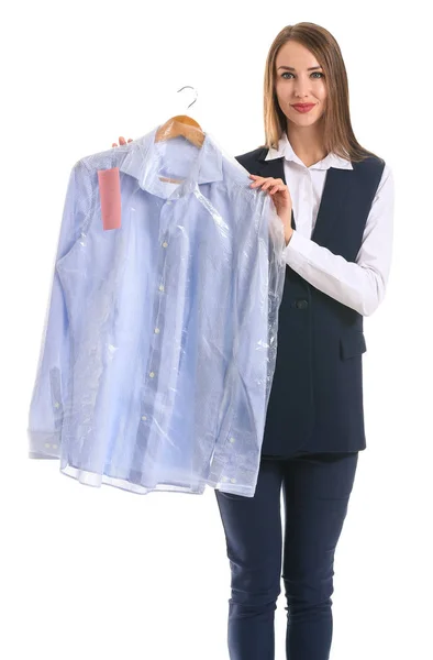 Female worker of modern dry-cleaner's with clothes on white background — Stock Photo, Image