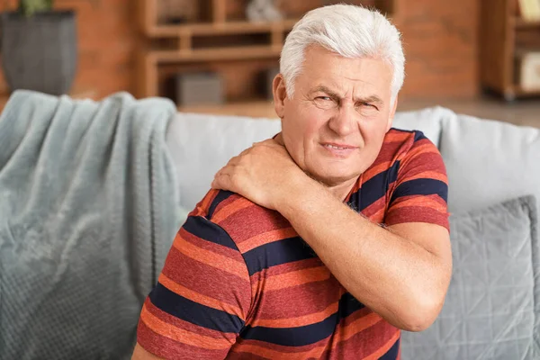 Senior man suffering from back pain at home — Stock Photo, Image