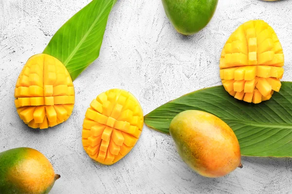 Sweet ripe mangoes on light background — Stock Photo, Image