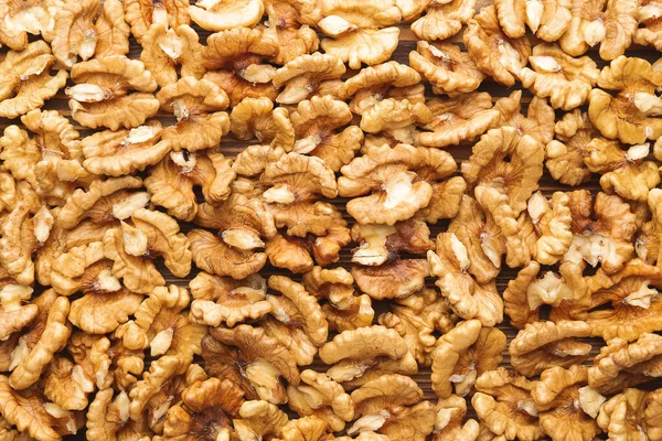 Many tasty walnuts as background — Stock Photo, Image