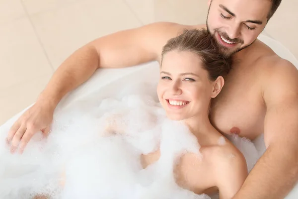 Happy young couple taking bath together — Stock Photo, Image