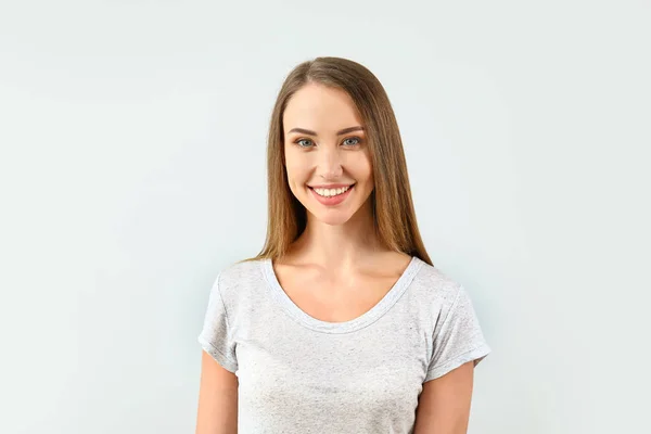 Beautiful young woman on light background — Stock Photo, Image