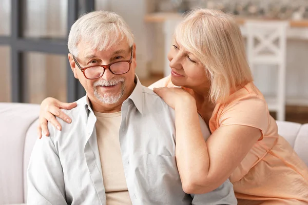 Happy mature couple resting together at home — Stock Photo, Image