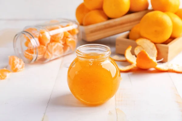 Jar of sweet tangerine jam on table — Stock Photo, Image