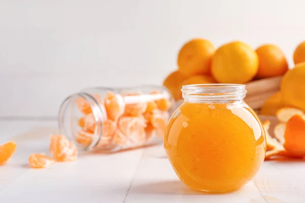 Jar of sweet tangerine jam on table — Stock Photo, Image