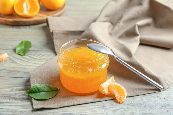 Jar of sweet tangerine jam on table — Stock Photo, Image