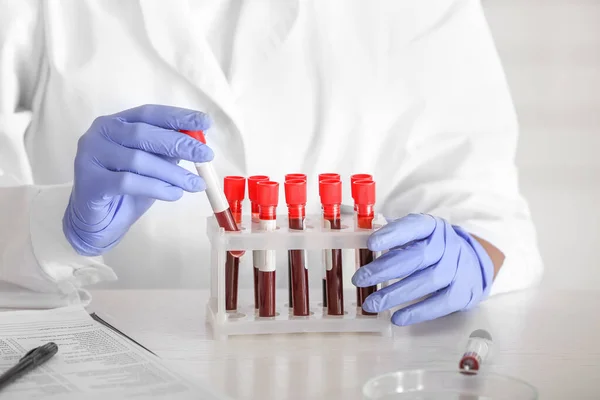 Woman working with blood sample in laboratory, closeup — Stock Photo, Image