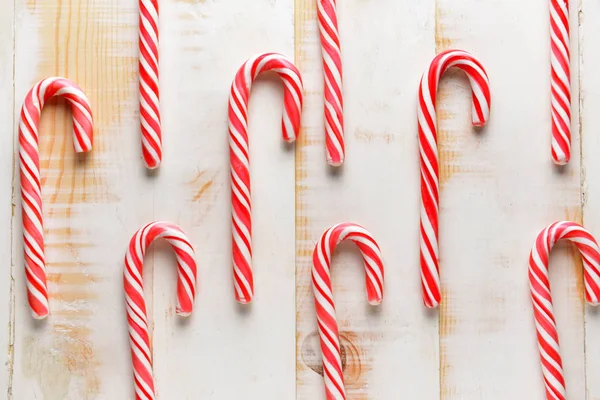 Candy canes on white wooden background — Stock Photo, Image