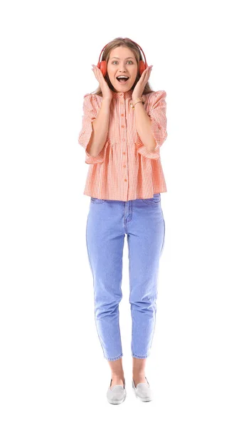 Happy young woman listening to music on white background — Stock Photo, Image