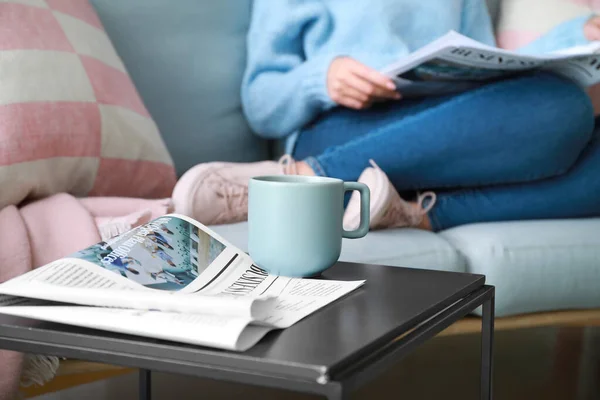 Newspaper and cup of coffee on table in room — Stock Photo, Image