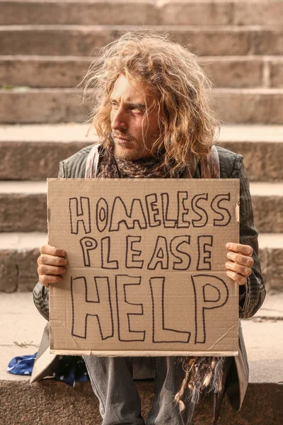 Portrait of poor homeless man sitting on stairs outdoors — Stock Photo, Image