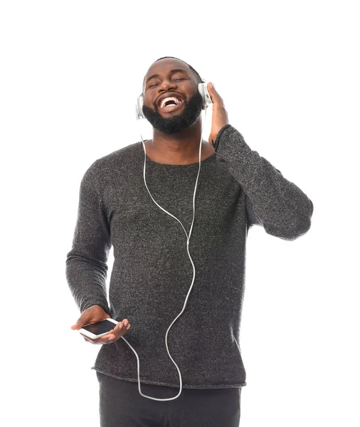 African-American man listening to music on white background — Stock Photo, Image