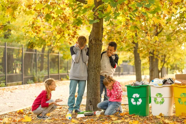 Malé děti sbírají odpadky venku. Koncept recyklace — Stock fotografie