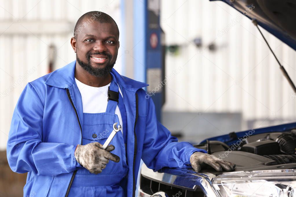 African-American mechanic working in car service center