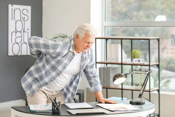 Senior man suffering from back pain at home — Stock Photo, Image