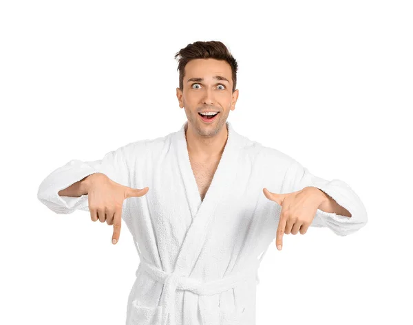 Excited man in bathrobe pointing at something on white background — Stock Photo, Image