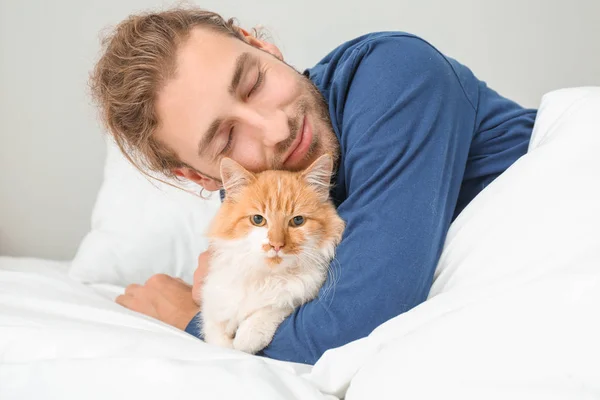 Morning of young man with cute cat in bedroom — Stock Photo, Image