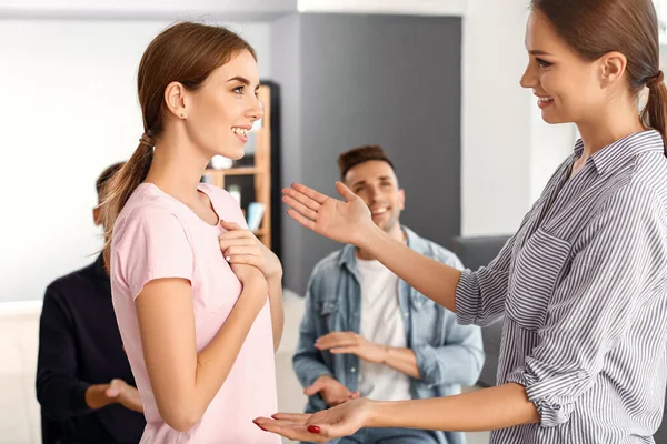 Woman calming sad friend during psychological support session — Stock Photo, Image