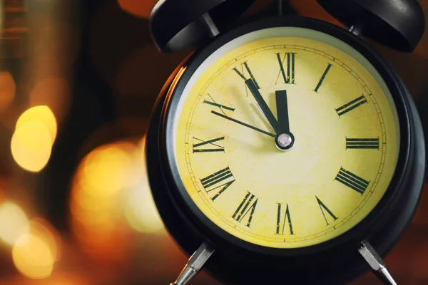 Alarm clock against defocused lights — Stock Photo, Image