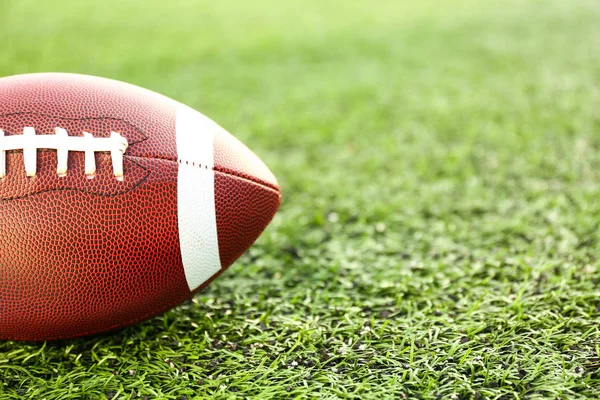 Rugby ball on green field outdoors — Stock Photo, Image