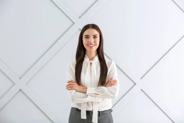 Beautiful young businesswoman on light background — Stock Photo, Image