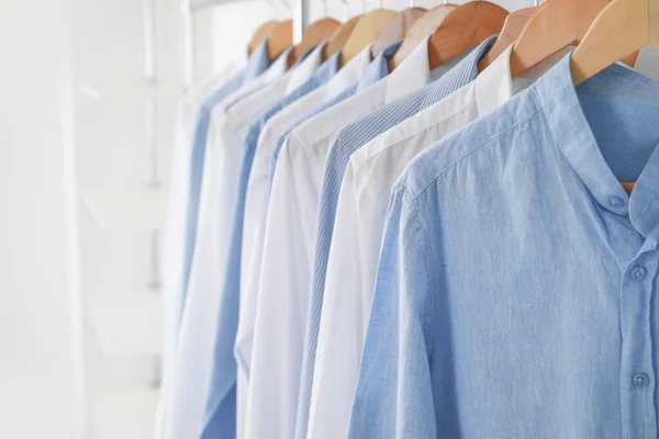 Rack with clothes in modern dry-cleaner's, closeup — Stock Photo, Image