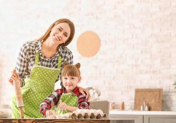 Happy mother and daughter cooking pastry at home — Stock Photo, Image